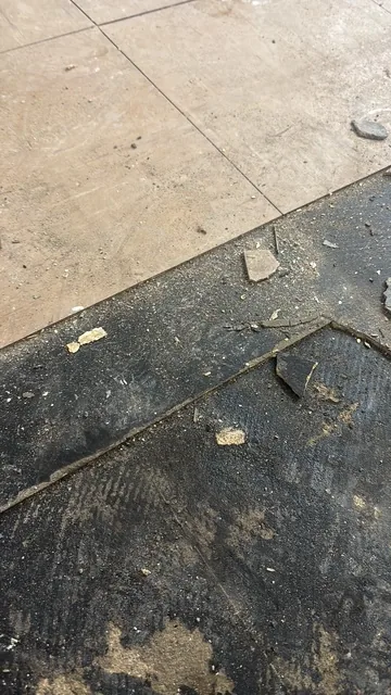 Black bitumen mastic floor removal in a SW9 flat